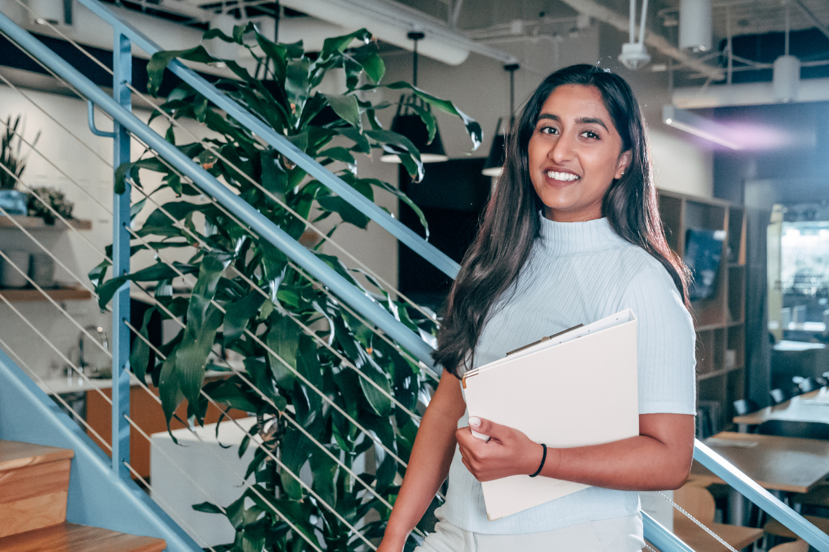 Professional woman holding a notebook. 