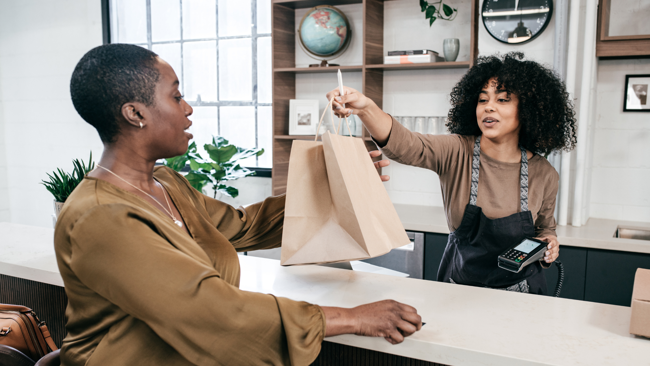 A women checking out at a retail store | Small Business Loans