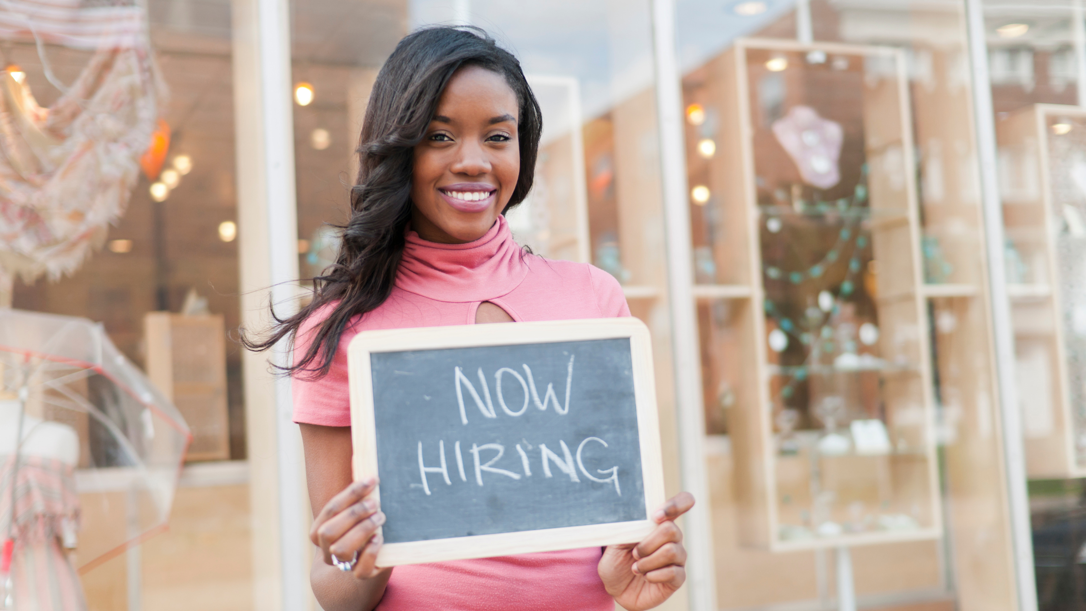 Woman hold a now hiring sign | What is Bamboo HR