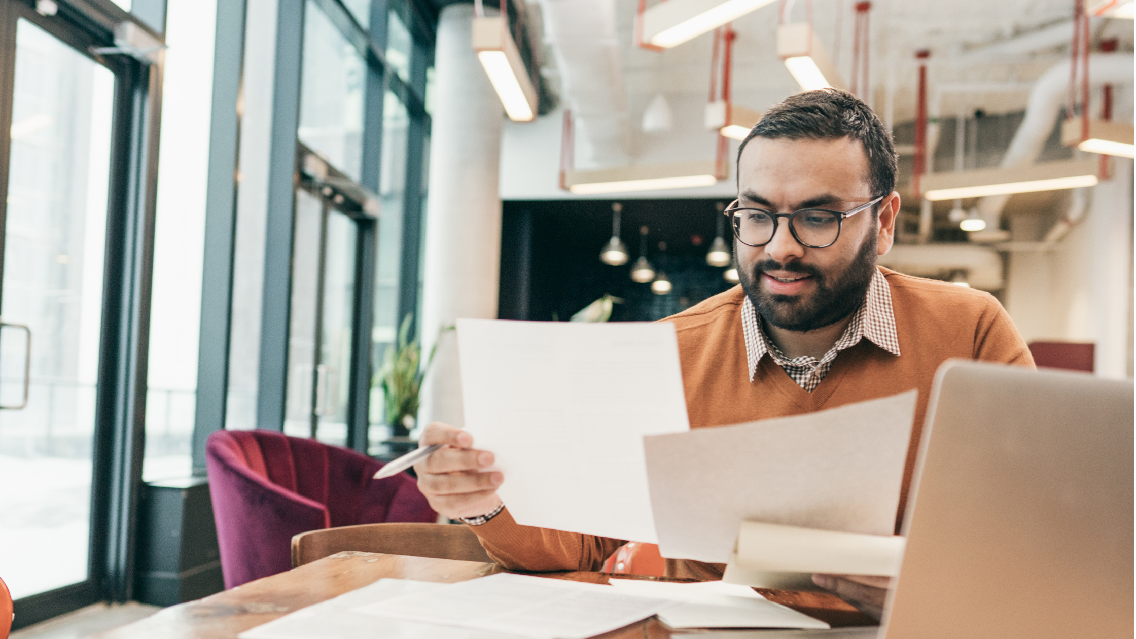 Common Loan Fees | Business owner reviewing paperwork