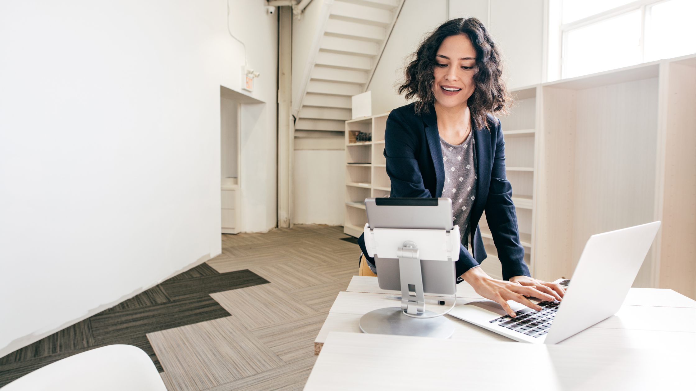 Marketing Tools for Small Businesses | Woman at her desk with a laptop