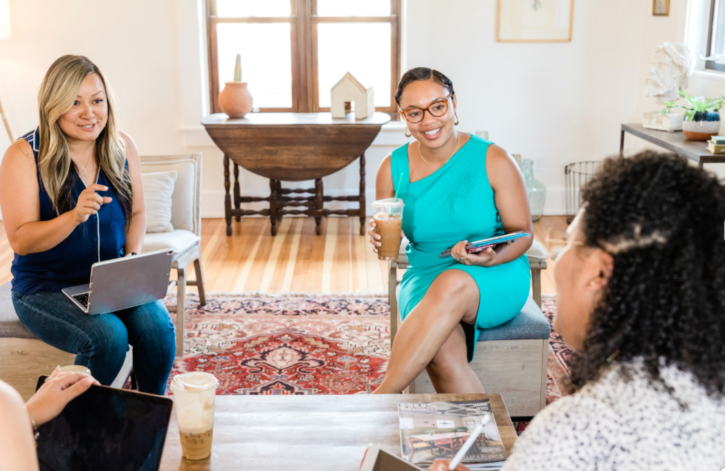 Women conversing in a meeting.