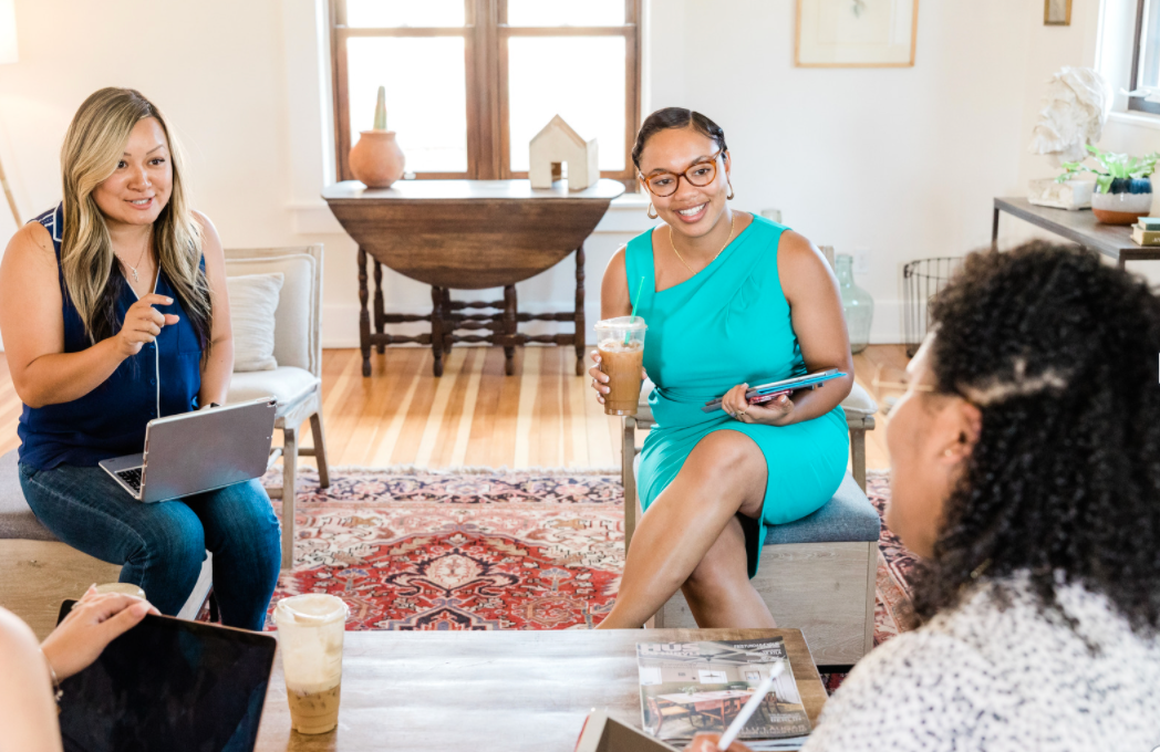 Women conversing in a meeting. 