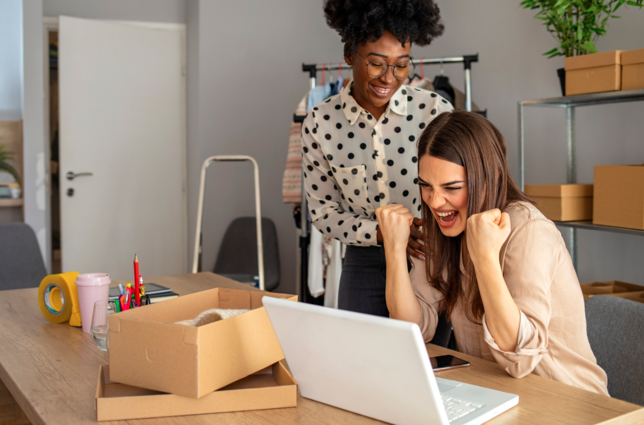 Two women looking at a laptop.