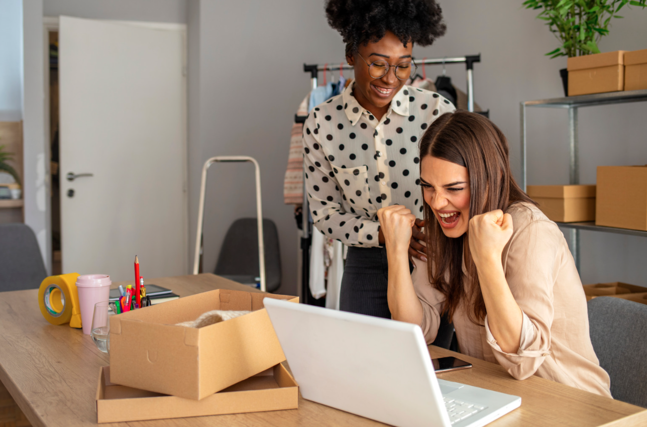 Two women looking at a laptop. 