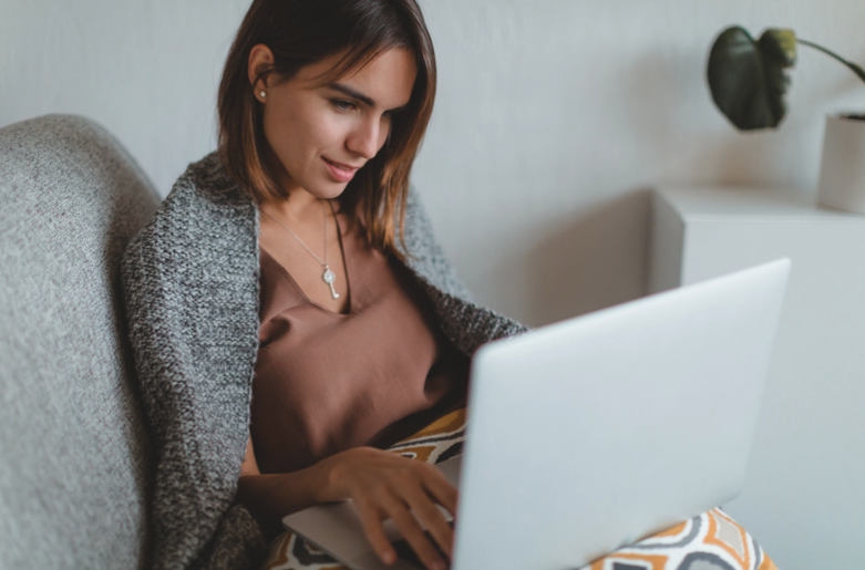 Woman working on laptop.