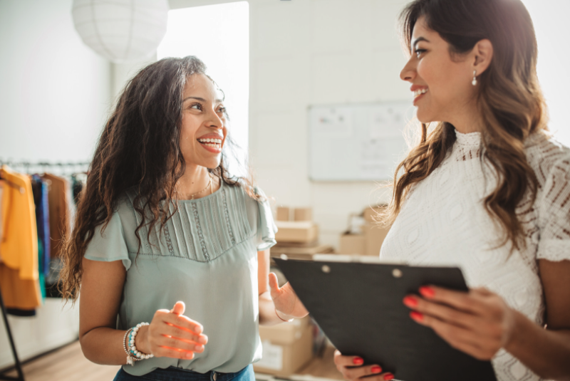 Two women talking at work | business equipment financing