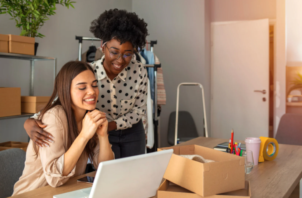 two women looking at a computer