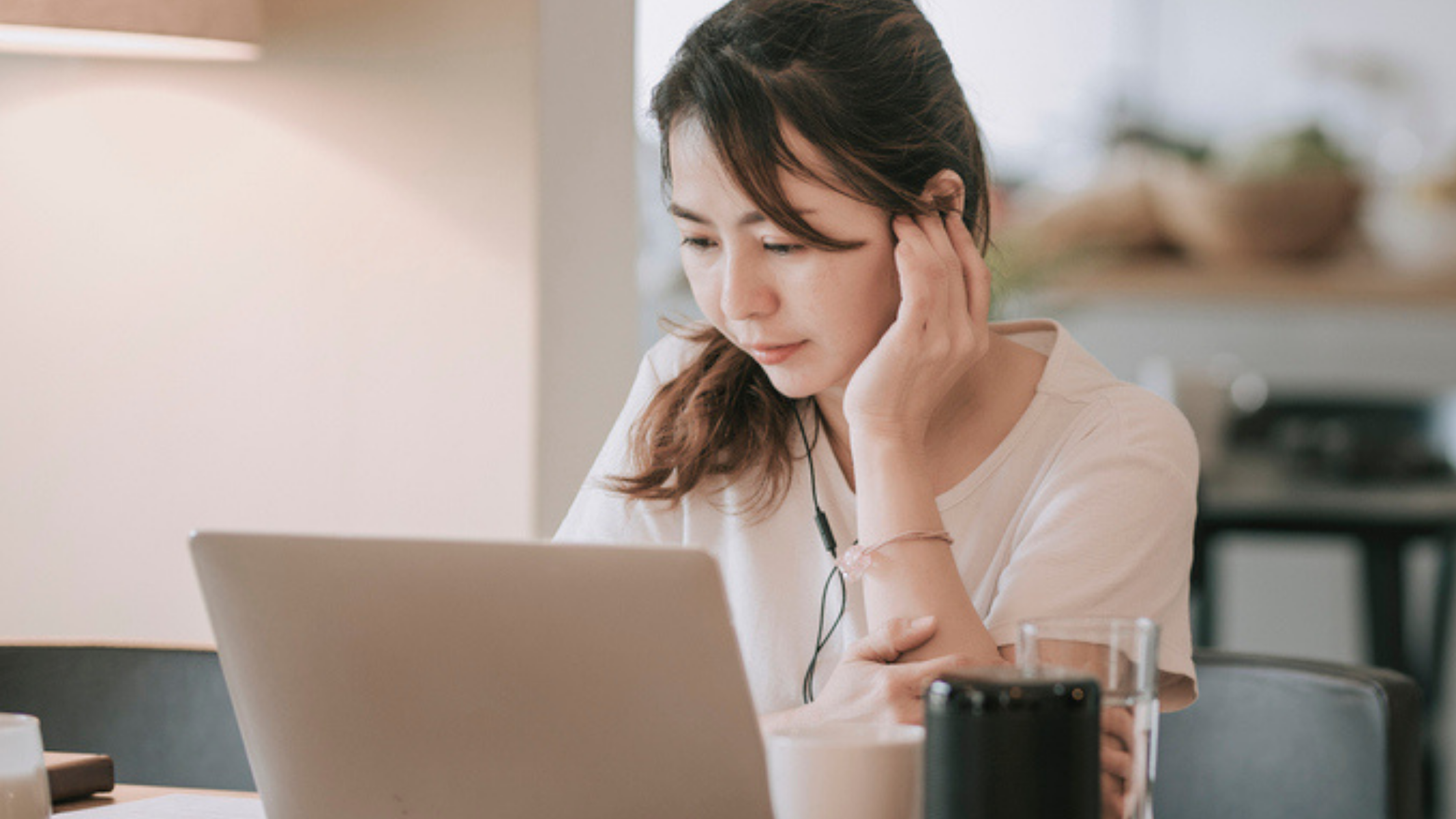 Woman working on a laptop.