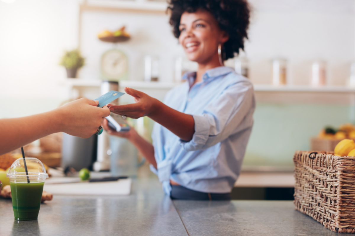 Women collecting payment from a customer. 