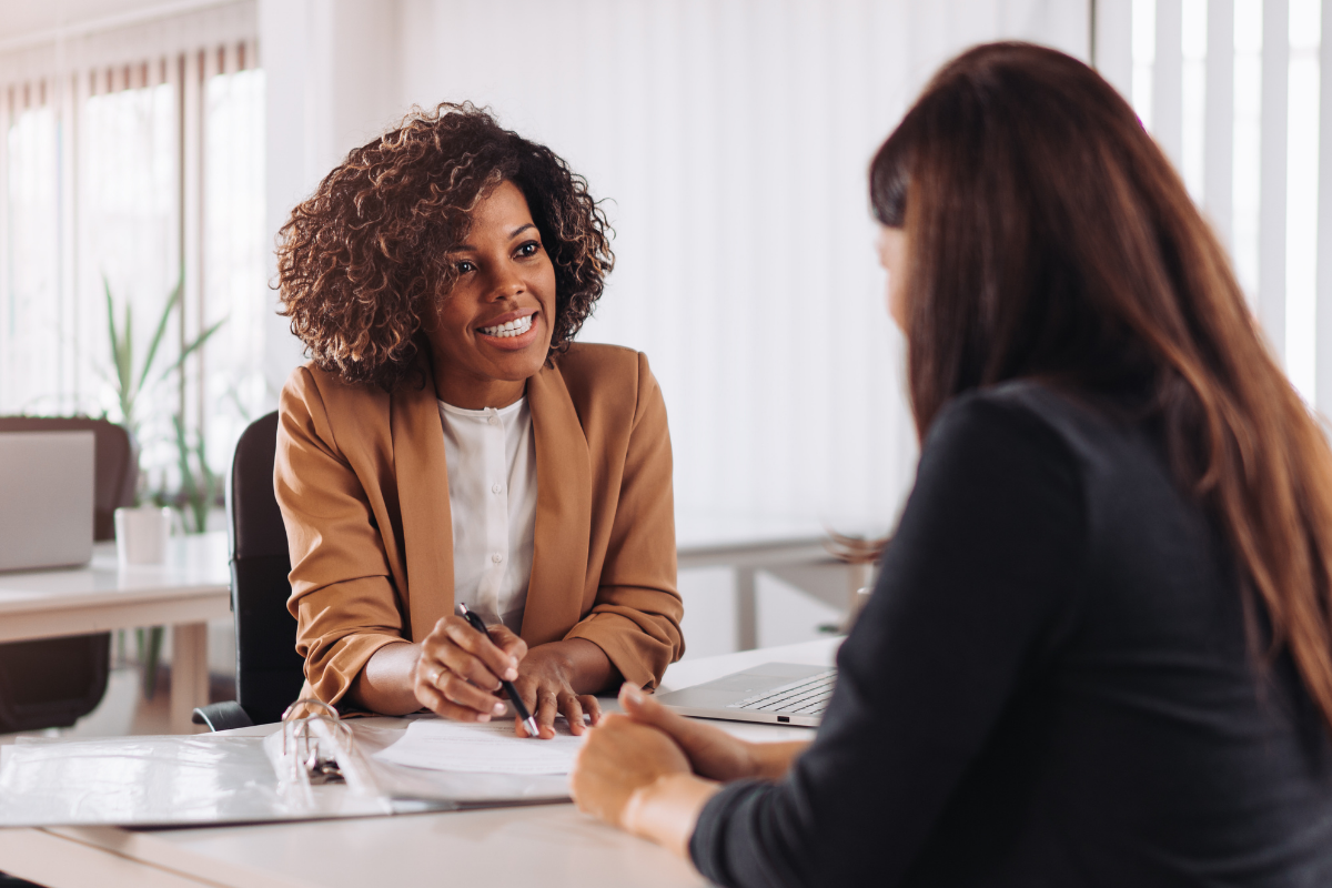 Woman consulting with a female financial manager at the bank | can you use a personal account for business Fundid